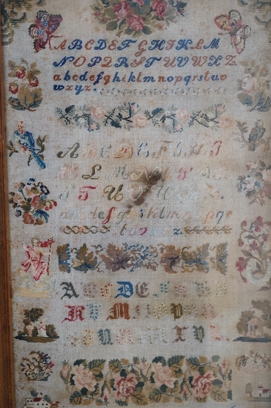 A 19th century framed alphabet sampler worked by M. Edlacher, overall 114cm high. Condition - poor